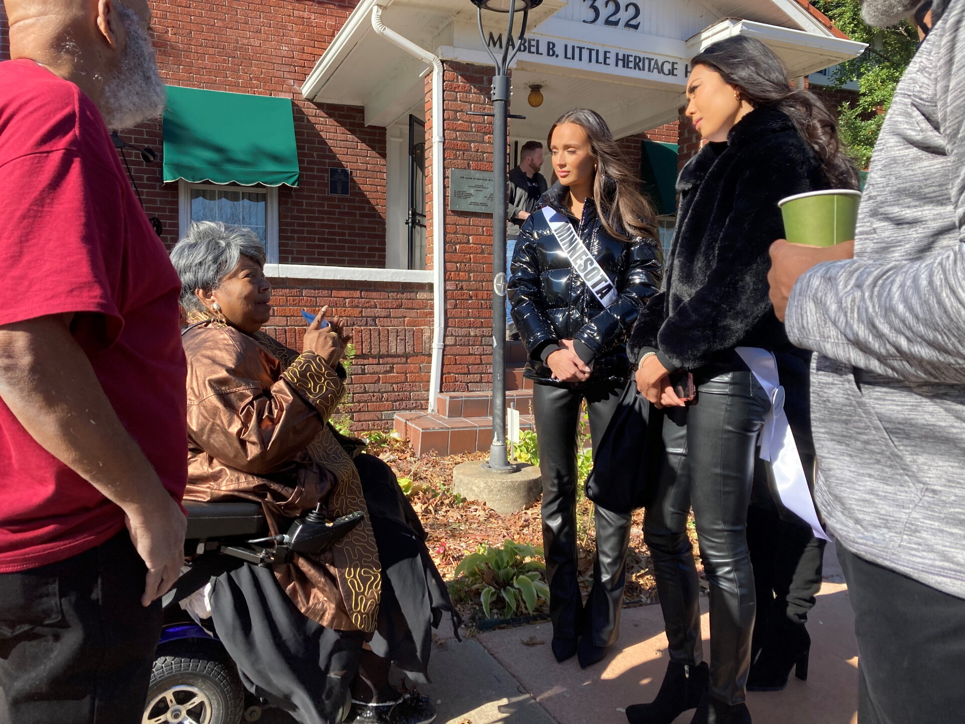Visitors gathered outside the Mabel B. Little Heritage House in Greenwood, talking with a community elder